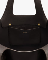 Open handbag with a pocket and gold buttons visible inside.