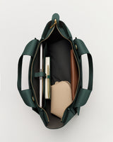 Open travel bag with books and pouches inside.