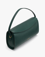 Handbag with a curved handle and flap closure.