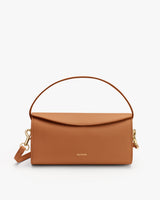 Handbag with a top handle and detachable strap.