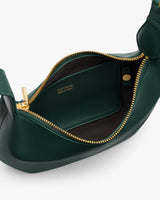 Open leather bag with visible zip and branded interior label.