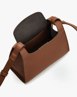 Small open handbag with a shoulder strap and visible interior pocket.