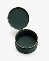 Round leather travel case with zipper, open to show inside compartments.
