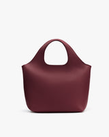Tote bag with a rounded handle placed against a plain background.