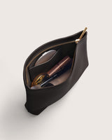 Open makeup bag with cosmetic items inside.