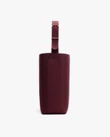 Side view of a tall bag with an adjustable strap.