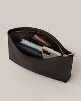 An open pouch containing a phone, wallet, and small items.