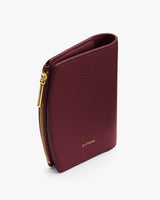 A small wallet with a zipper partially open on one side.