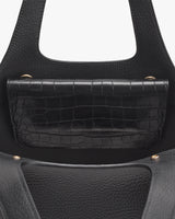 Handbag with croc-embossed leather flap and round handles.