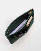 Open handbag showing a phone and a book inside.