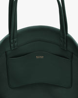 Close-up of a bag with a front pocket and two handles.
