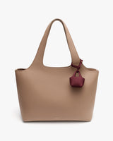 Tote bag with curved handles and small attached pouch.