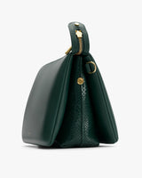 Side view of handbag with croc-embossed leather detail and zipper closure.