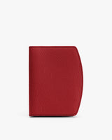 Red textured passport holder standing upright.