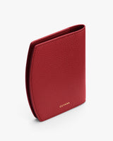 Textured leather passport holder standing upright