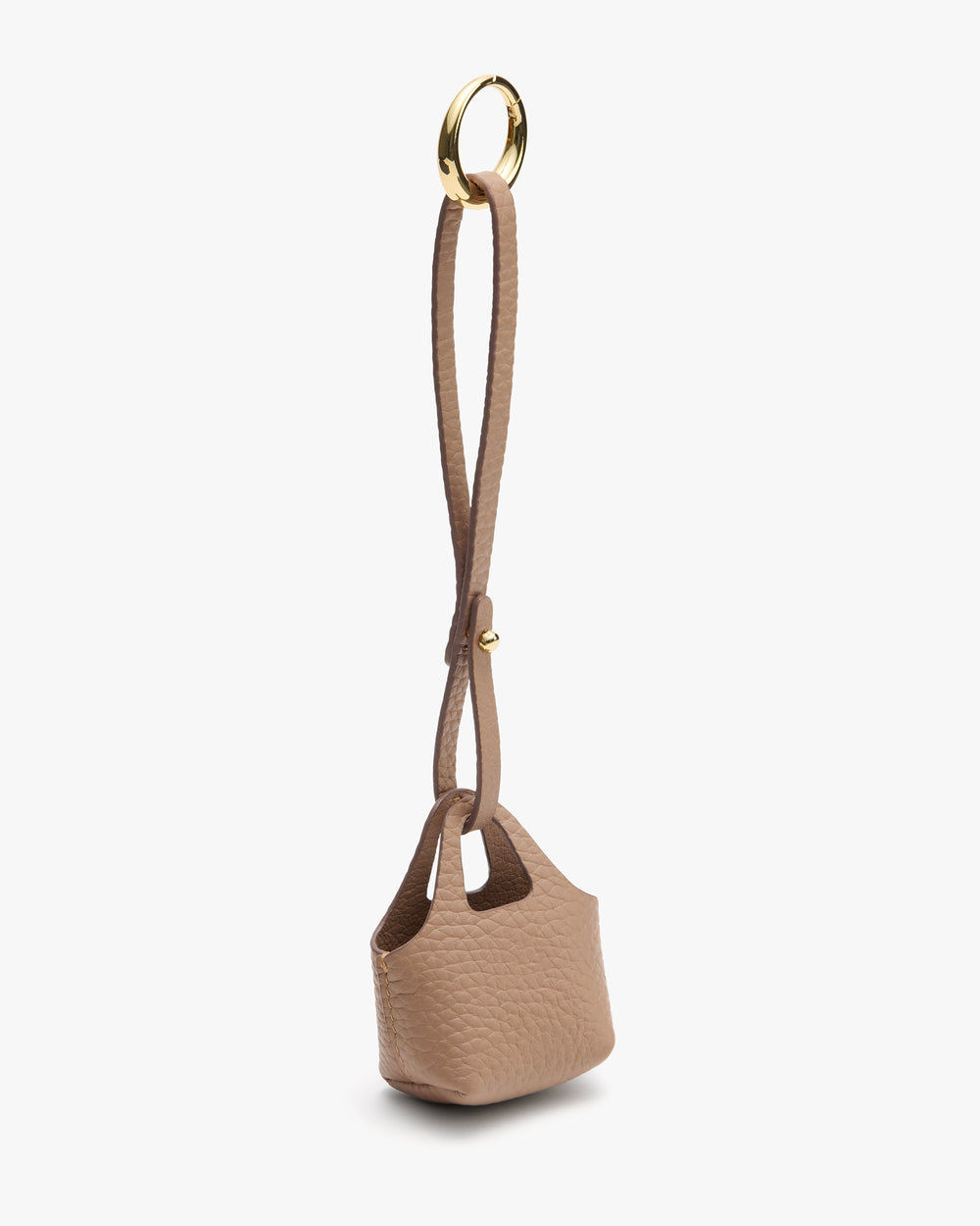 System Tote Charm Small textured handbag with a long strap and circular metal handle attachment.