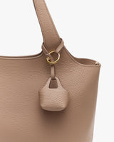 Bag with attached mini bag and a gold ring detail.