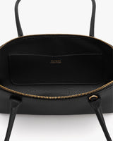 Open handbag showing interior and zip pocket.
