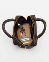 Open handbag with phone, wallet, keys, and cards inside.