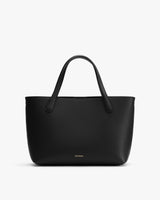 Handbag with two handles and brand logo near the bottom.