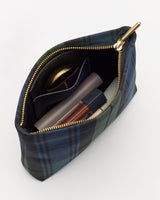 Plaid pouch with zipper, containing lipstick, compact, and other small items.