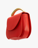 A handbag with a curved handle and flap.