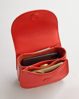 Open belt bag with phone, wallet, and pen inside