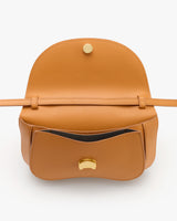 Open handbag with flap lifted and visible interior pocket