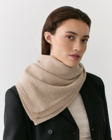 Person wearing a scarf and blazer, facing the camera.
