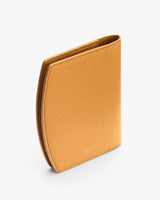 Textured wallet standing upright on white background