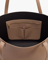 Open handbag with two handles, showing interior pocket with zipper and two compartments.