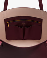 Open handbag showing interior pocket and zipper detail