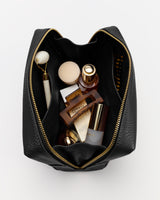 Open travel bag with various toiletries inside