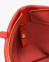 Open bag interior showing a zipper pocket and snap button strap.