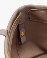 Open bag interior with zipper pocket and button tab.
