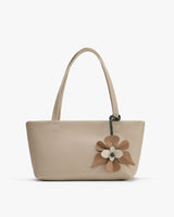 Handbag with floral decoration and two handles.