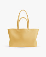Large tote bag with two handles on a plain background