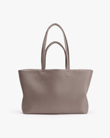 Tote bag with dual handles on a plain background