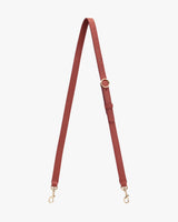 Adjustable strap with metal clasps and a buckle loop.