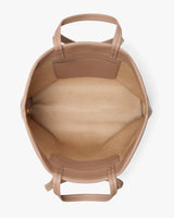 Open travel bag with handles and pocket inside.