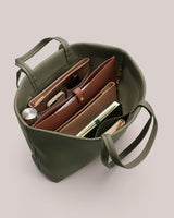 Open handbag with organized compartments and items inside.