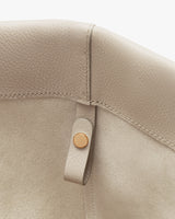 Close-up of leather corner with a button detail.