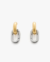 Pair of two-tone hoop earrings on white background.