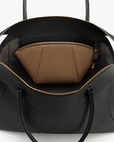 Open travel bag with a zippered pocket inside.