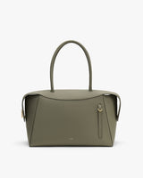Handbag with curved handles and vertical zipper detail.