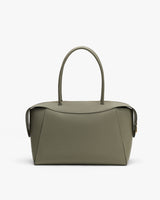 Elegant handbag with simple design and curved handles.