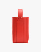 A tall, structured handbag with a single handle on top.