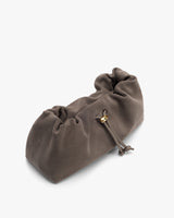 Soft, gathered purse with drawstring closure, resting on a flat surface.
