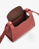 Open handbag with top flap and shoulder strap.