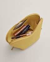Open cosmetic bag with makeup items inside.